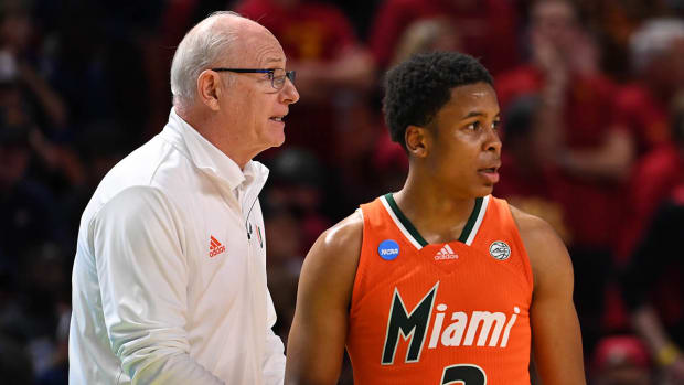Miami Hurricanes head coach Jim Larranaga talks with Miami Hurricanes guard Charlie Moore (3) against the Southern California Trojans during the first round of the 2022 NCAA tournament at Bon Secours Wellness Arena.