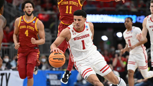 Wisconsin Badgers guard Johnny Davis (1) drives to the basket against Iowa State Cyclones guard Tyrese Hunter (11) during the first half during the second round of the 2022 NCAA Tournament.