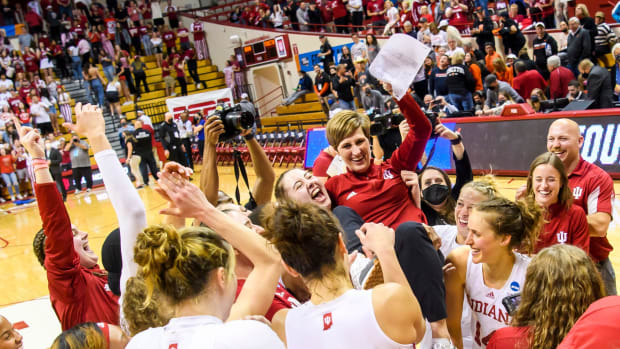 The Indiana women's basketball team holds up Coach Teri Moren after advancing to the Sweet Sixteen.