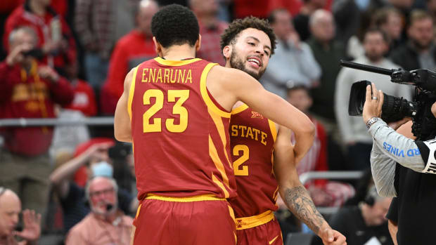 Iowa State basketball players embrace after a play.