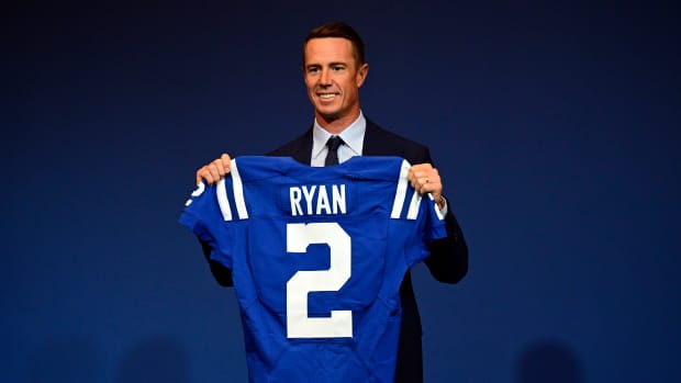 Mar 22, 2022; Indianapolis, IN, USA; Indianapolis Colts Quarterback Matt Ryan (2) holds up his new uniform after a press conference to announce his joining of the team at Indiana Farm Bureau Football Center. Mandatory Credit: Marc Lebryk-USA TODAY Sports