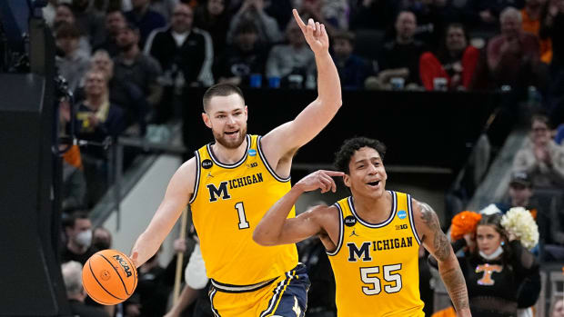 Michigan’s Hunter Dickinson (1), and Eli Brooks (55) celebrate after they defeated Tennessee in a college basketball game in the second round of the NCAA tournament, Saturday, March 19, 2022, in Indianapolis.