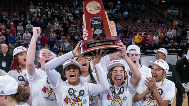 Mar 28, 2022; Wichita, KS, USA; Louisville Cardinals hoist the regional champion trophy after winning the game against the Michigan Wolverines in the Wichita regional finals of the women’s college basketball NCAA Tournament at INTRUST Bank Arena.