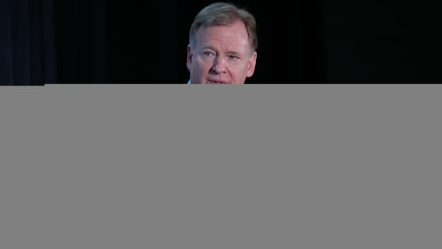 Roger Goodell speaks in front of a microphone during a press conference.