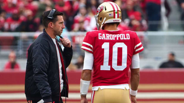 49ers coach Kyle Shanahan talks with quarterback Jimmy Garoppolo on the sidelines between plays.