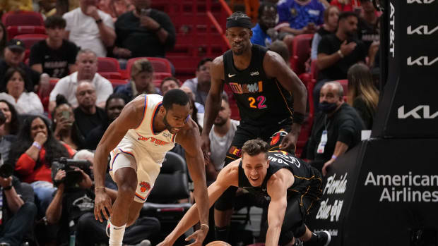 Mar 25, 2022; Miami, Florida, USA; New York Knicks guard Alec Burks (18) and Miami Heat guard Duncan Robinson (55) chase a loose ball during the first half at FTX Arena. Mandatory Credit: Jasen Vinlove-USA TODAY Sports