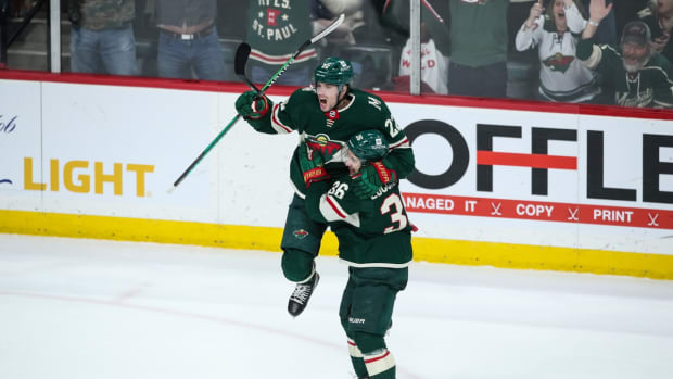 Mar 27, 2022; Saint Paul, Minnesota, USA; Minnesota Wild left wing Kevin Fiala (22) celebrates his game-winning goal against the Colorado Avalanche with right wing Mats Zuccarello (36) in overtime at Xcel Energy Center. Mandatory Credit: David Berding-USA TODAY Sports