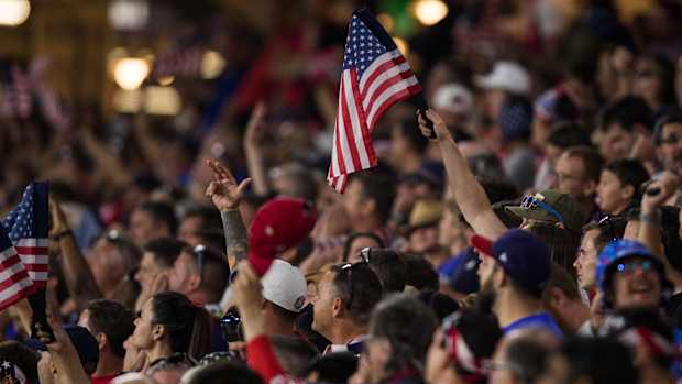 United States men’s national team supporters cheer from the stands during a game.