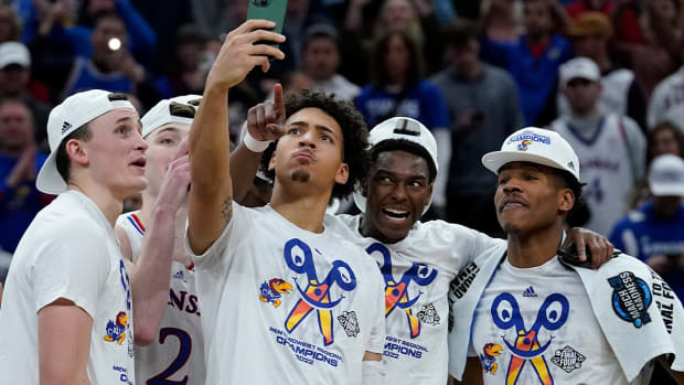 Kansas players celebrate after a college basketball game in the Elite 8 round of the NCAA tournament Sunday, March 27, 2022, in Chicago. Kansas won 76-50 to advance to the Final Four.
