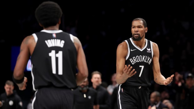 Brooklyn Nets forward Kevin Durant (7) reacts to guard Kyrie Irving (11) during the third quarter against the Detroit Pistons at Barclays Center. The Nets defeated the Pistons, 130–123.