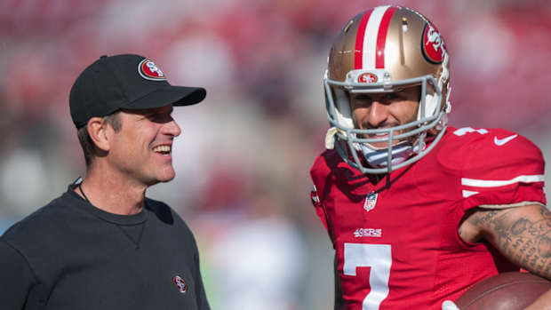 San Francisco 49ers head coach Jim Harbaugh talks with quarterback Colin Kaepernick (7)