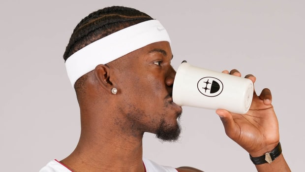 Miami Heat forward Jimmy Butler (22) drinks from a coffee cup with his logo for Big Face Coffee.