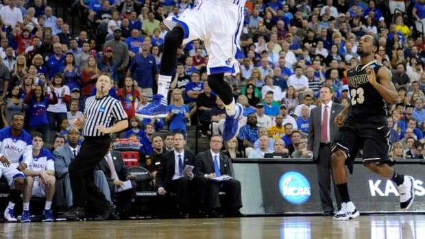 Mar 18, 2012; Omaha, NE, USA; Kansas Jayhawks guard Tyshawn Taylor (10) drives in for a dunk past Purdue Boilermakers guard Lewis Jackson (23) during the second half in the third round of the 2012 NCAA men's basketball tournament at the CenturyLink Center. Kansas defeated Purdue 63-60. Mandatory Credit: Peter G. Aiken-USA TODAY Sports