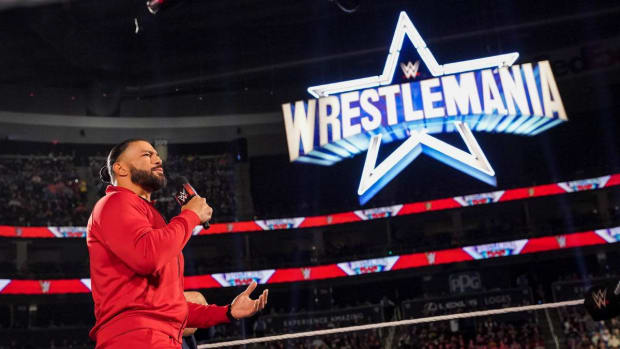 Roman Reigns speaks with the WrestleMania sign in the background