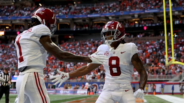 Alabama Crimson Tide wide receiver John Metchie III (8) celebrates his touchdown with wide receiver Jameson Williams (1) during the first quarter against the Miami Hurricanes at Mercedes-Benz Stadium.