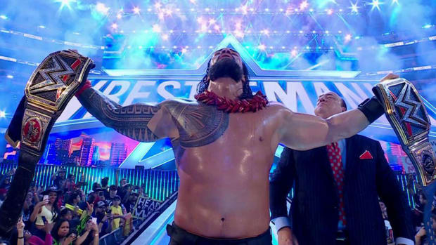 Roman Reigns celebrates WrestlemMania 38 win.