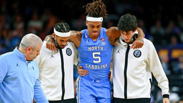 Apr 2, 2022; New Orleans, LA, USA; North Carolina Tar Heels forward Armando Bacot (5) is helped off the court after sustaining an apparent injury after a play against the Duke Blue Devils during the second half during the 2022 NCAA men’s basketball tournament Final Four semifinals at Caesars Superdome.