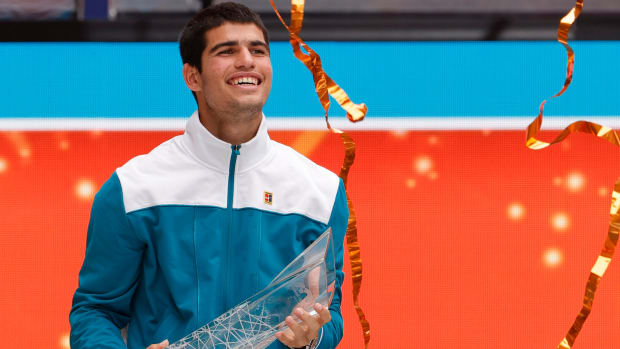 Carlos Alcaraz holds a trophy after winning the Miami Open.