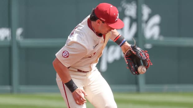 Arkansas third baseman Cayden Wallace tries to snag a tough hop against Mississippi State. Wallace is one of several former shortstops starting the infield for Arkansas.