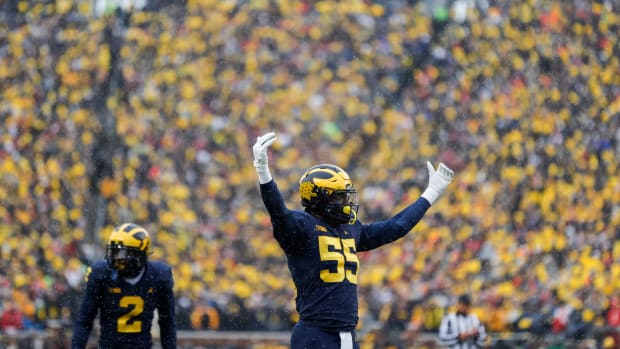 Michigan linebacker David Ojabo cheers the crowd before a play against Ohio State during the first half at Michigan Stadium in Ann Arbor on Saturday, Nov. 27, 2021.