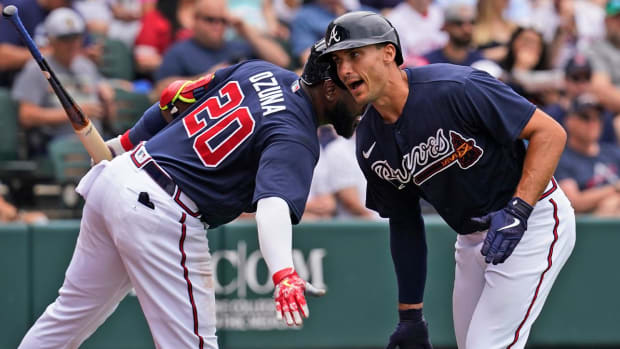 Atlanta Braves first baseman Matt Olson, right, gets a low-five from teammate Marcell Ozuna (20) as he celebrates a first-inning home run during a spring training baseball game against the Boston Red Sox at CoolToday Park, Sunday, April 3, 2022, in North Port, Fla.