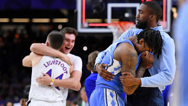 North Carolina Tar Heels guard Caleb Love (2) is consoled after losing the 2022 NCAA men’s basketball tournament Final Four championship game against the Kansas Jayhawks at Caesars Superdome.