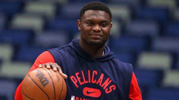 Pelicans star Zion Williamson holds a basketball during pregame warmups.