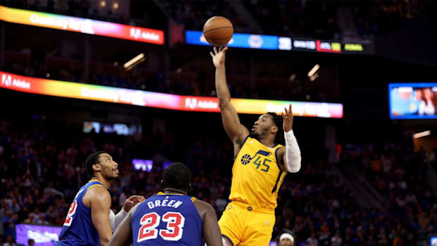 Utah Jazz guard Donovan Mitchell (45) shoots against Golden State Warriors forwards Otto Porter Jr., left, and Draymond Green (23) during the second half of an NBA basketball game in San Francisco, Saturday, April 2, 2022.