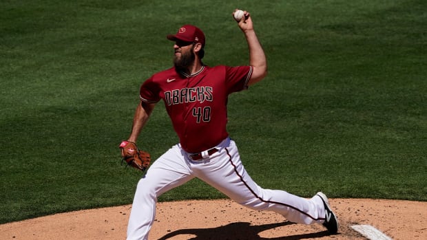 Arizona Diamondbacks starting pitcher Madison Bumgarner (40) throws against the Texas Rangers during the first inning of a spring training baseball game Tuesday, March 22, 2022, in Scottsdale, Ariz.