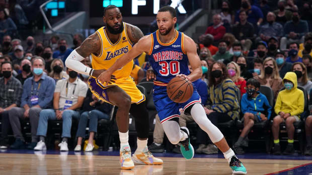 LeBron James defends Stephen Curry in a game.