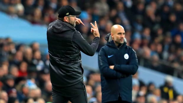 Pep Guardiola (right) and Jurgen Klopp pictured on the touchline during a game between Manchester City and Liverpool in 2019