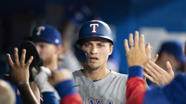 Apr 8, 2022; Toronto, Ontario, CAN; Texas Rangers shortstop Corey Seager (5) celebrates in the dugout after scoring a run during the fourth inning against the Toronto Blue Jays at Rogers Centre . Mandatory Credit: Nick Turchiaro-USA TODAY Sports