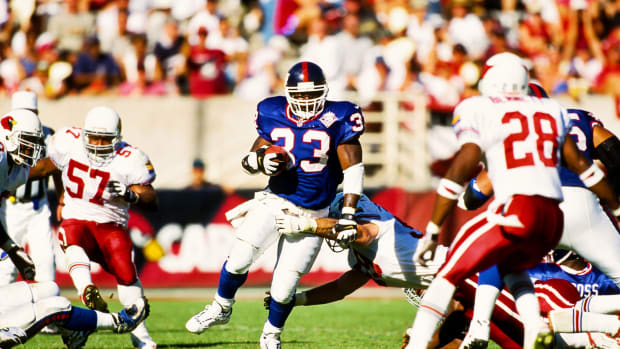 Oct 10, 1999; Tempe, AZ, USA; FILE PHOTO; New York Giants running back Gary Brown (33) in action against Arizona Cardinals defenders Tommy Bennett (28) and Ronald McKinnon (57) at Sun Devil Stadium.