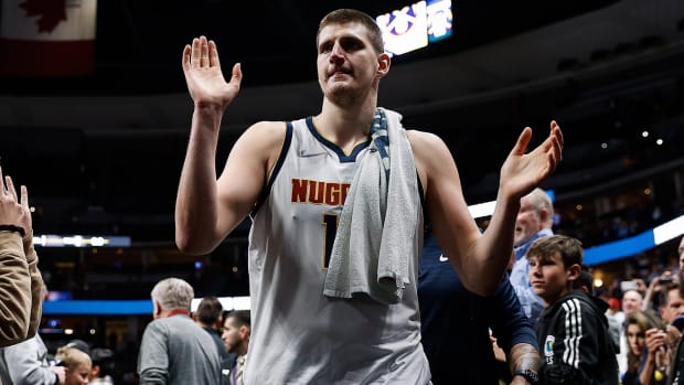 Denver Nuggets center Nikola Jokic (15) gestures to fans as he walks off the court after the game against the Memphis Grizzlies.