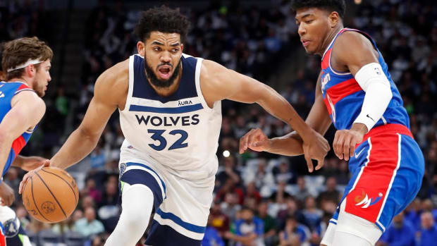 Minnesota Timberwolves center Karl-Anthony Towns (32) works around Washington Wizards forward Rui Hachimura (8) in the first quarter of an NBA basketball game Tuesday, April 5, 2022, in Minneapolis.
