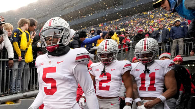 Ohio State Buckeyes wide receivers Garrett Wilson (5), Chris Olave (2) and Jaxon Smith-Njigba (11) take the the field for the NCAA football game against the Michigan Wolverines at Michigan Stadium in Ann Arbor on Sunday, Nov. 28, 2021. Ohio State Buckeyes At Michigan Wolverines