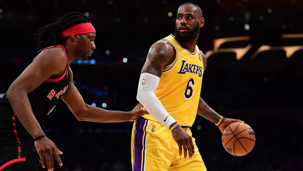 Los Angeles Lakers forward LeBron James (6) controls the ball against Toronto Raptors forward Precious Achiuwa.