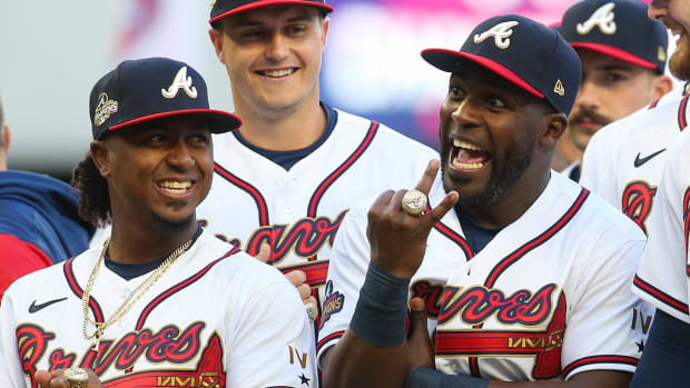 Atlanta Braves second baseman Ozzie Albies (1) and center fielder Guillermo Heredia (38) celebrate after receiving World Series championship rings