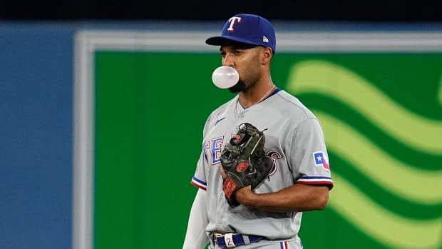 Apr 10, 2022; Toronto, Ontario, CAN; Texas Rangers second baseman Marcus Semien (2) blows a bubble during the ninth inning against the Toronto Blue Jays at Rogers Centre. Mandatory Credit: John E. Sokolowski-USA TODAY Sports