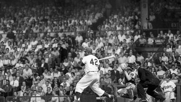 Brooklyn Dodgers second baseman Jackie Robinson (42) awaits a pitch at home plate during a game against the Milwaukee Braves in Brooklyn on Thursday, Aug. 2, 1956. Brooklyn defeated Milwaukee, 3–0.