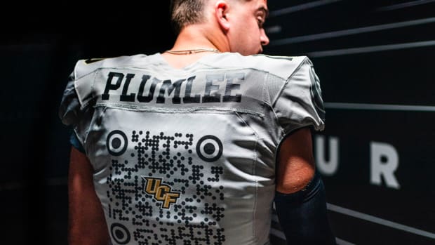 UCF’s John Rhys Plumlee shows off team’s QR code-emblazoned spring jersey.
