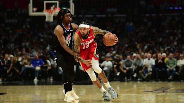 Apr 15, 2022; Los Angeles, California, USA; New Orleans Pelicans forward Brandon Ingram (14) moves the ball against Los Angeles Clippers guard Terance Mann (14) during the first half of the play in game at Crypto.com Arena.