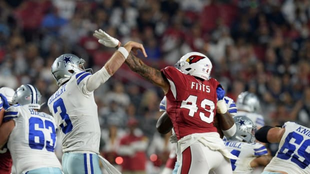 Aug 13, 2021; Glendale, Arizona, USA; Dallas Cowboys quarterback Garrett Gilbert (3) is hit by Arizona Cardinals linebacker Kylie Fitts (49) during the first half of a preseason game at State Farm Stadium.