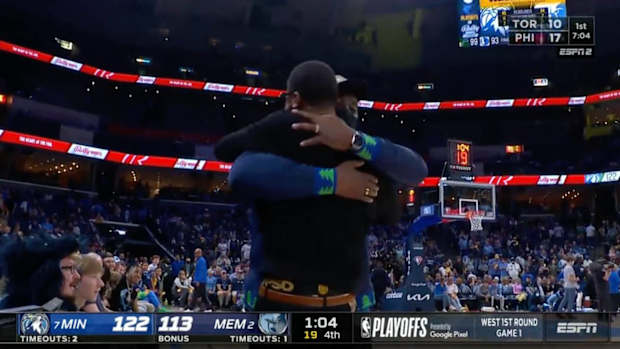 Fathers of Grizzlies guard Ja Morant and Timberwolve center Karl-Anthony Towns embrace during Memphis’ home game against Minnesota.