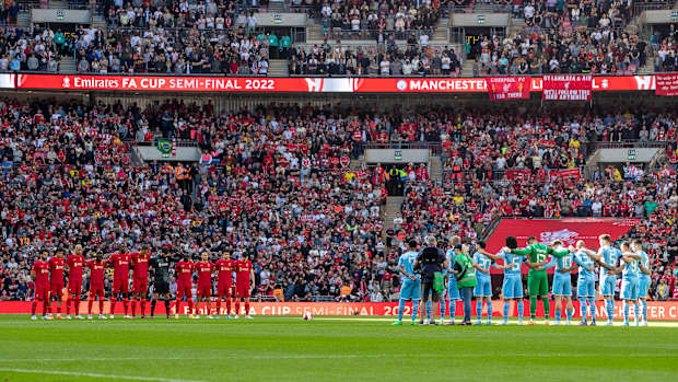 Manchester City and Liverpool players line up for a moment of silence for the Hillsborough disaster before a game.