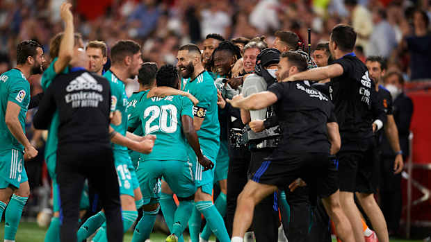 Karim Benzema celebrates with his Real Madrid teammates after a goal.
