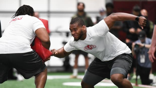 Evan Neal works at Alabama's Pro Day