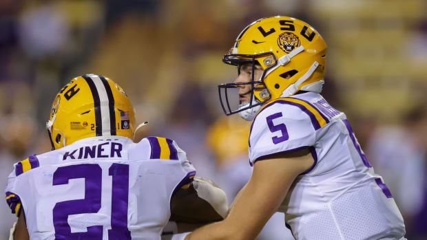 Sep 11, 2021; Baton Rouge, Louisiana, USA; LSU Tigers quarterback Garrett Nussmeier (5) hands the ball off to running back Corey Kiner (21) against the McNeese State Cowboys during the second half at Tiger Stadium. Mandatory Credit: Stephen Lew-USA TODAY Sports