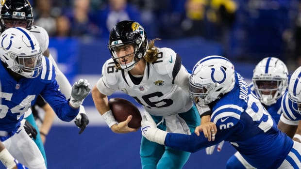 Nov 14, 2021; Indianapolis, Indiana, USA; Jacksonville Jaguars quarterback Trevor Lawrence (16) runs the ball while Indianapolis Colts defensive tackle DeForest Buckner (99) defends in the second half at Lucas Oil Stadium.