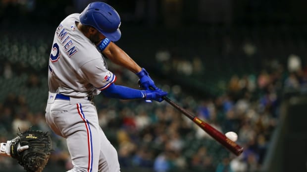 Apr 19, 2022; Seattle, Washington, USA; Texas Rangers second baseman Marcus Semien (2) hits an RBI-double against the Seattle Mariners during the fifth inning at T-Mobile Park. Mandatory Credit: Joe Nicholson-USA TODAY Sports